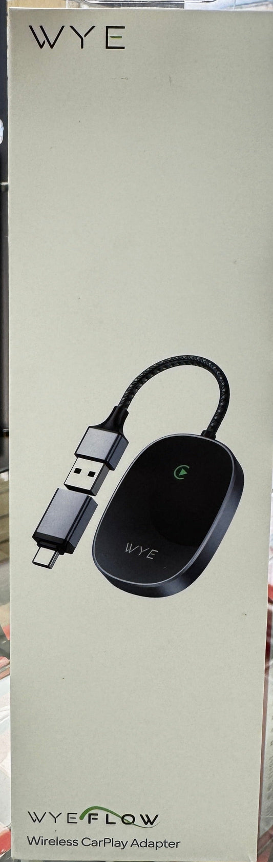 VYE wireless charging adapter on a clear stand with a blurred store background