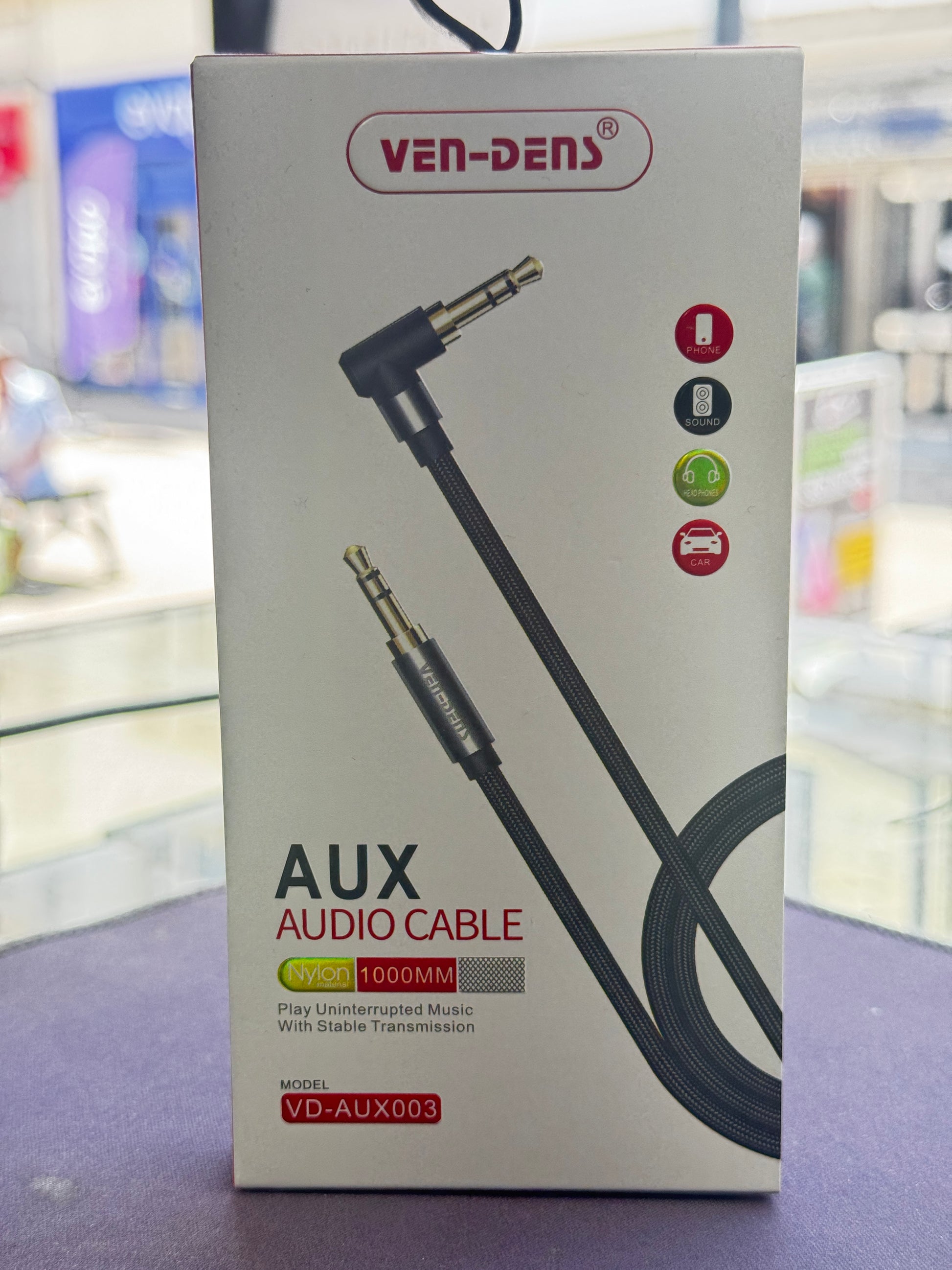 Box of VenDen AUX audio cable on a blurred background
