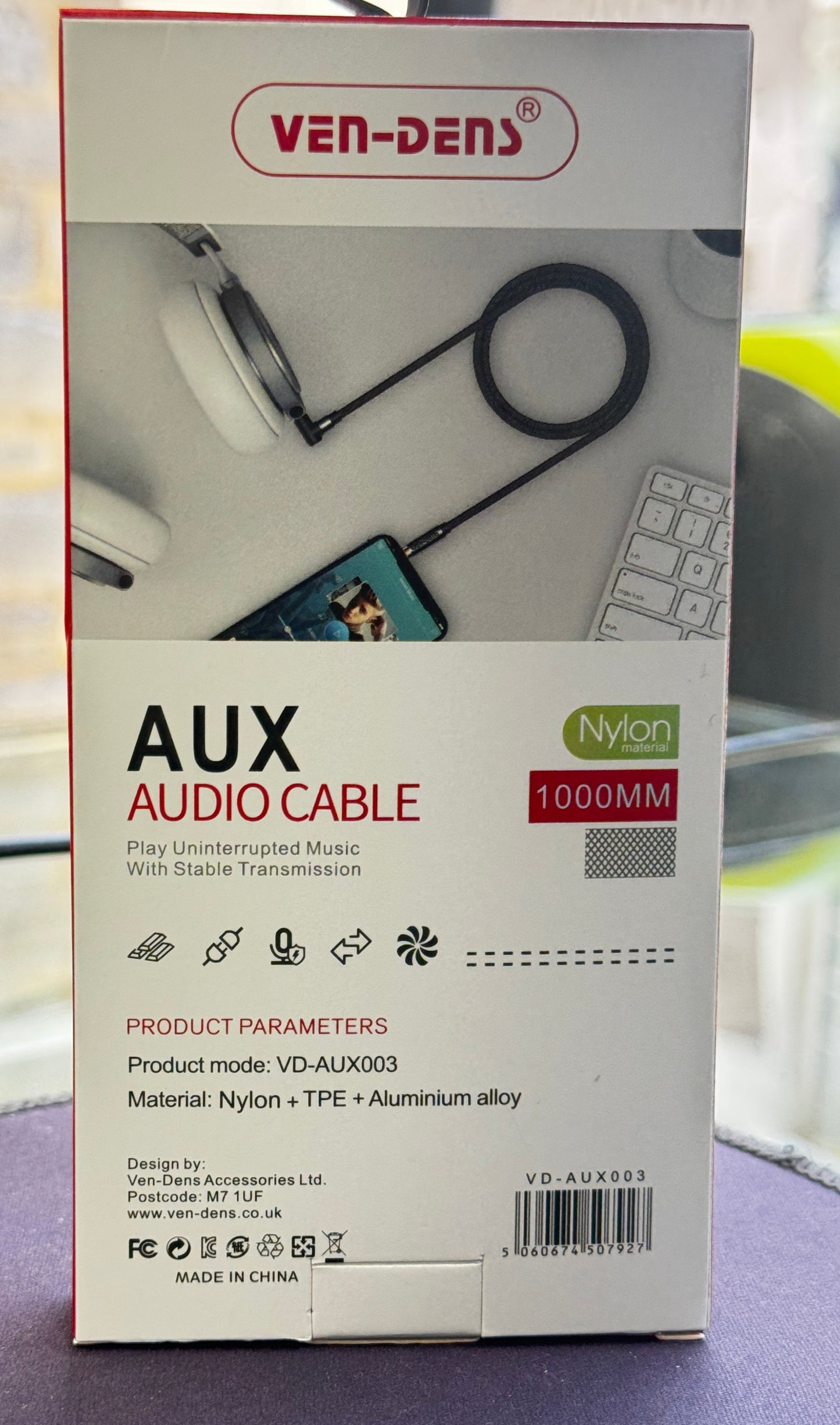 Box of VenDen Aux audio cable on a car seat