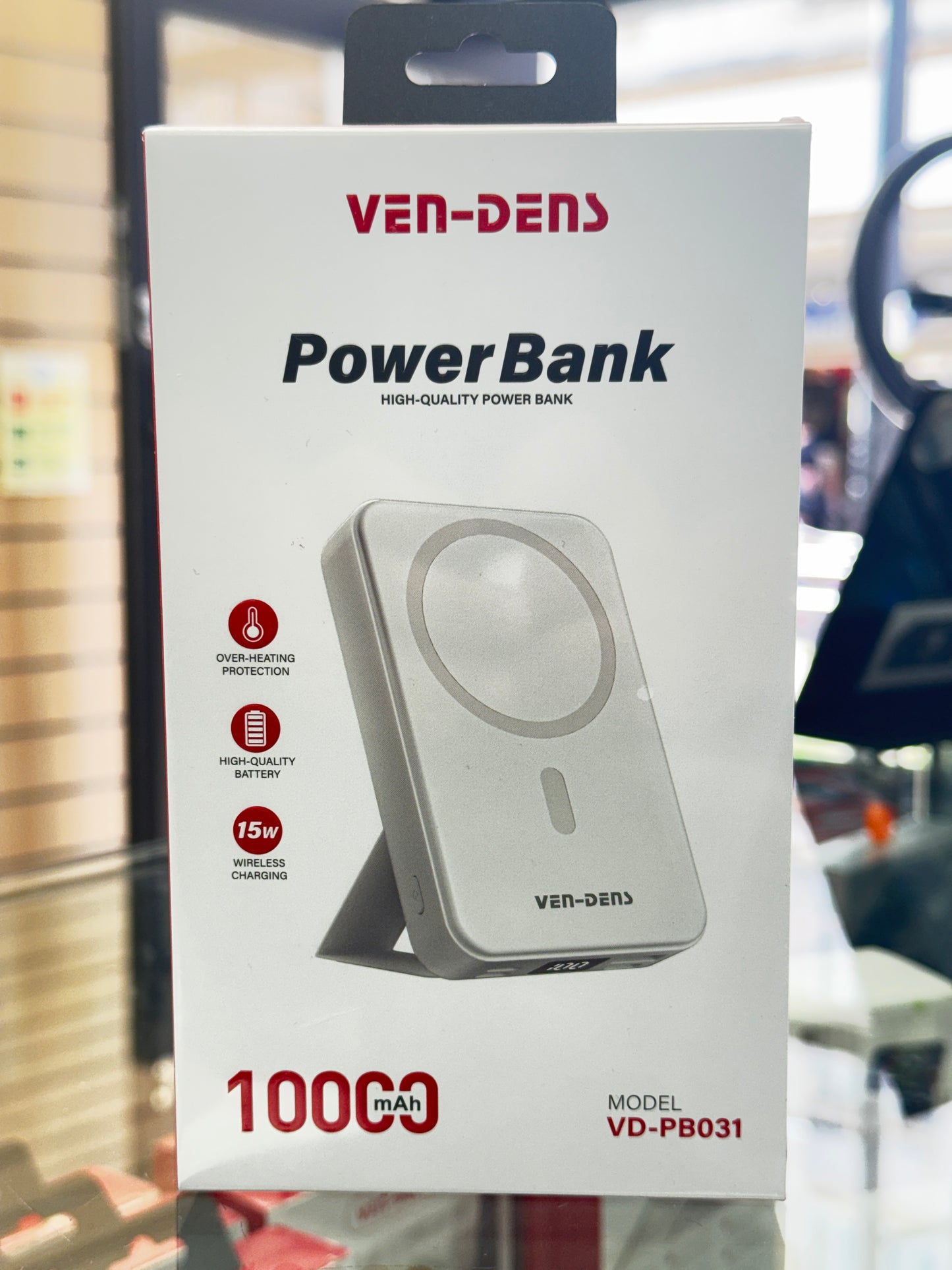 Power bank packaging with Ven-Dens branding on a blurred background