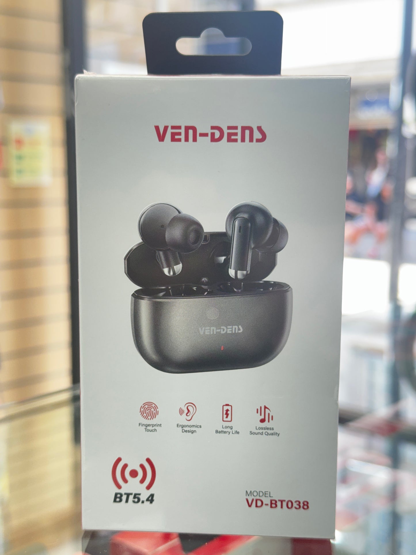 VenDen wireless earbuds packaging with product image and branding on a blurred background